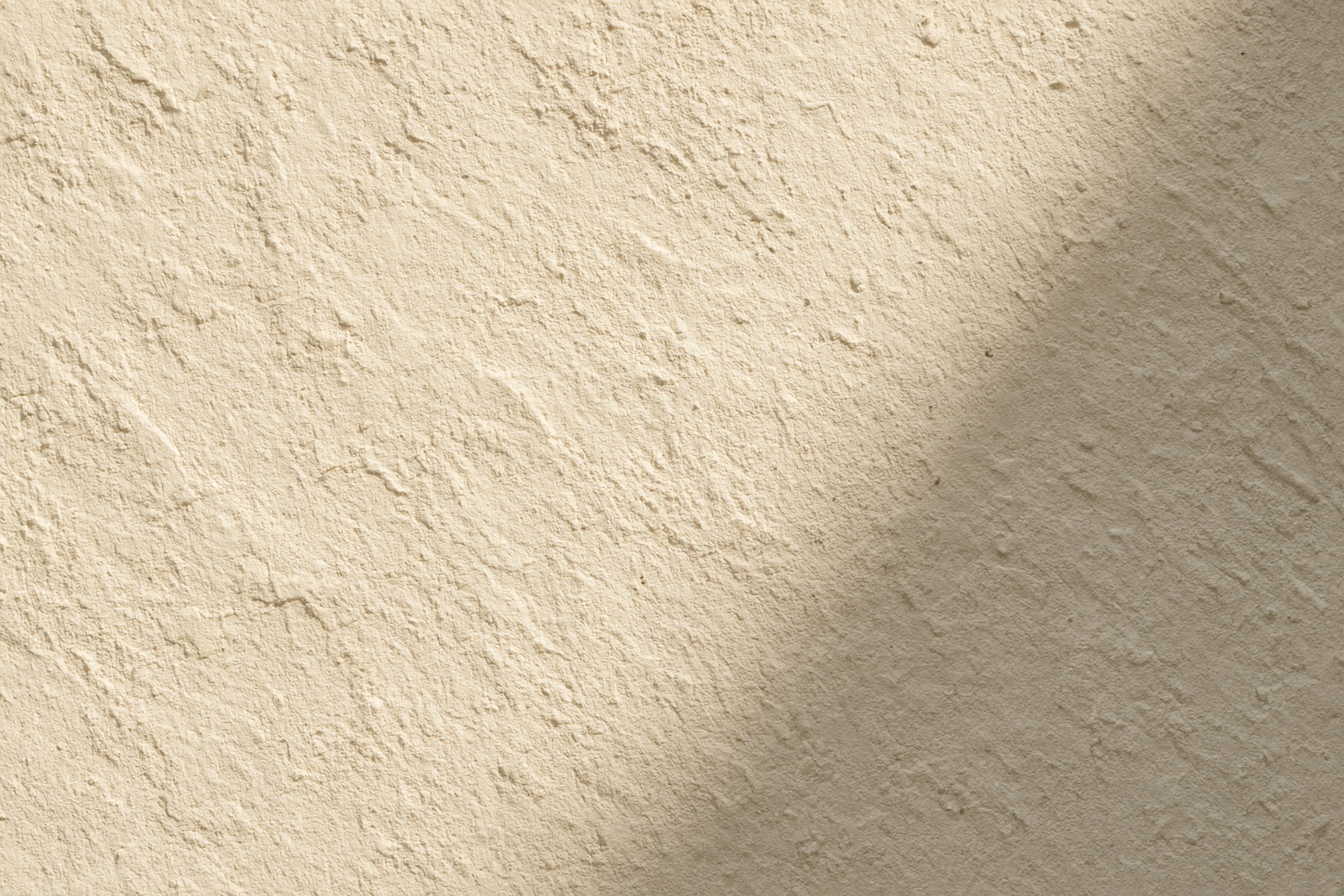 Hand-troweled cream Santa Barbara stucco in Arizona sun